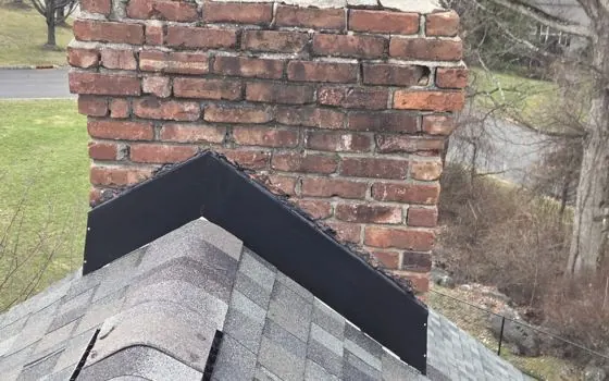 Black flashing on a brick chimney