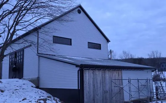 Black gutters on white siding