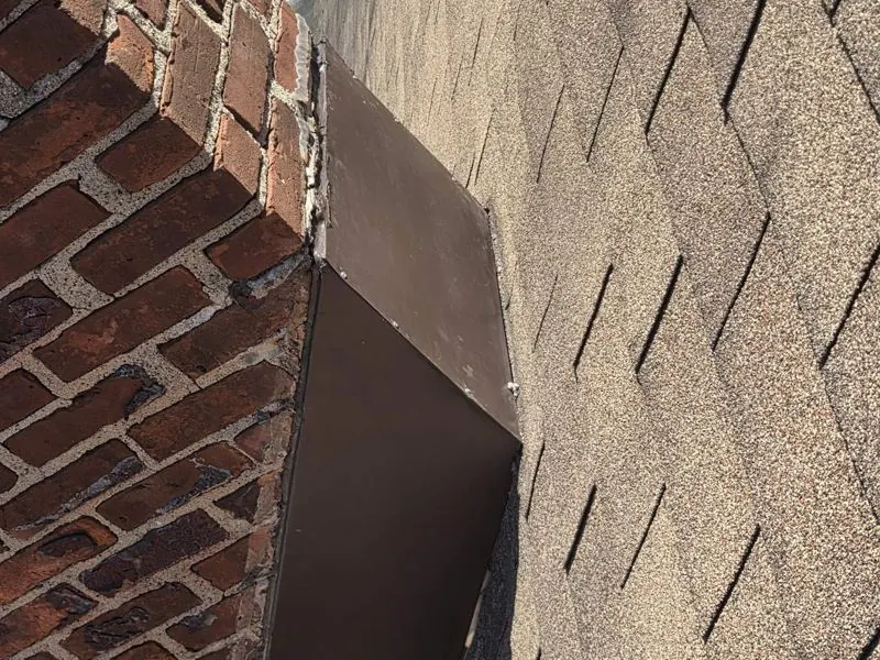Brown chimney flashing on brick