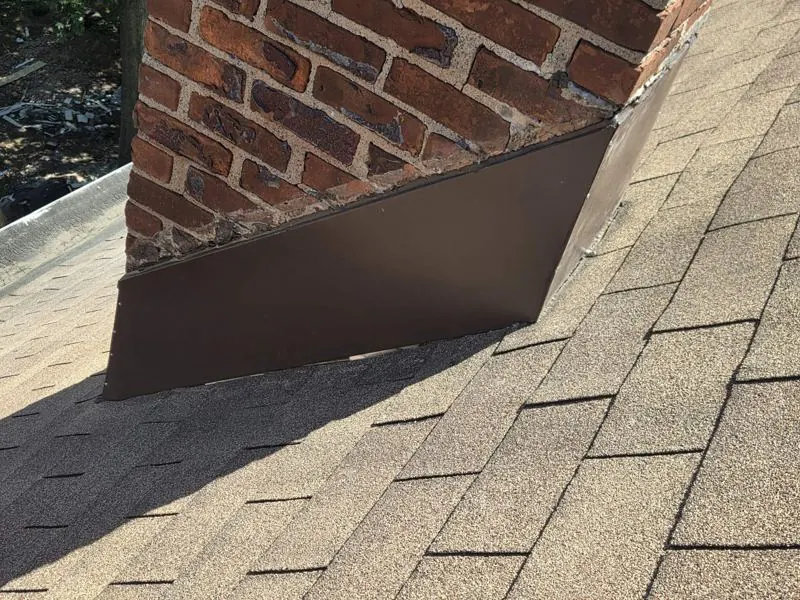 Brown chimney flashing on shingles