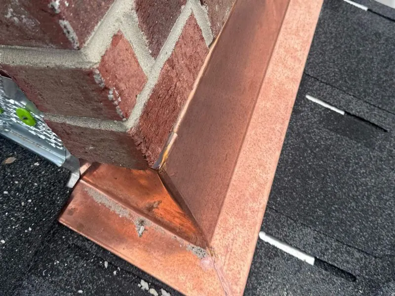 Copper chimney flashing on brick