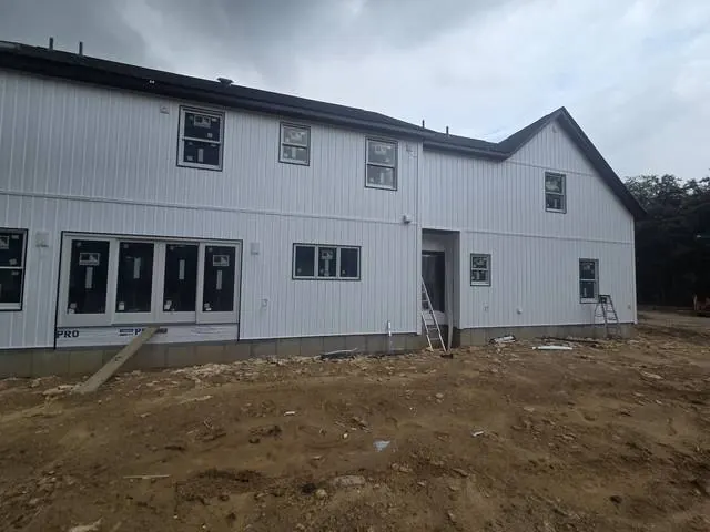 Gray vertical siding with new windows