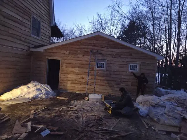 Rough-sawn wood siding on a garage