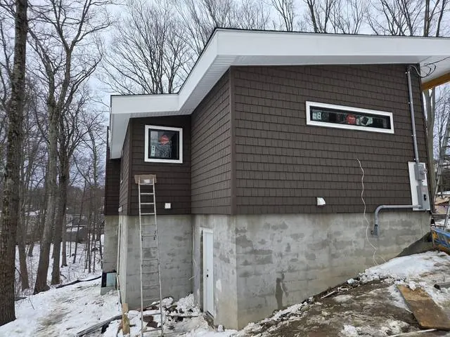 White fascia and soffit overhang on shingle siding
