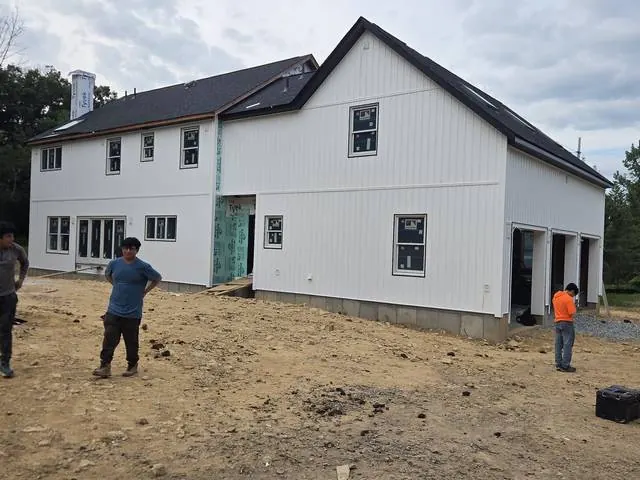 White vertical siding on a new addition